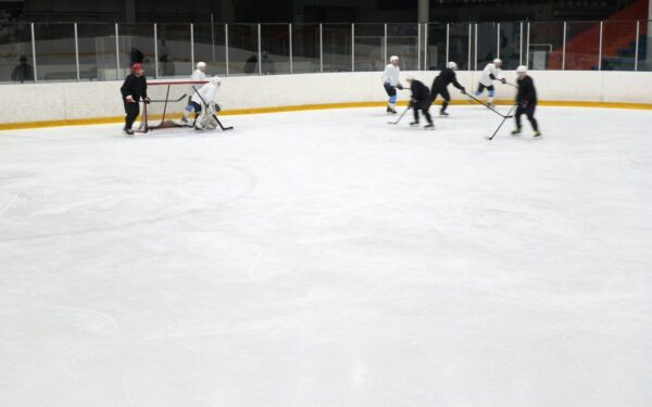 sidney crosby: Dynamic hockey match indoors with players skating and maneuvering on an ice rink